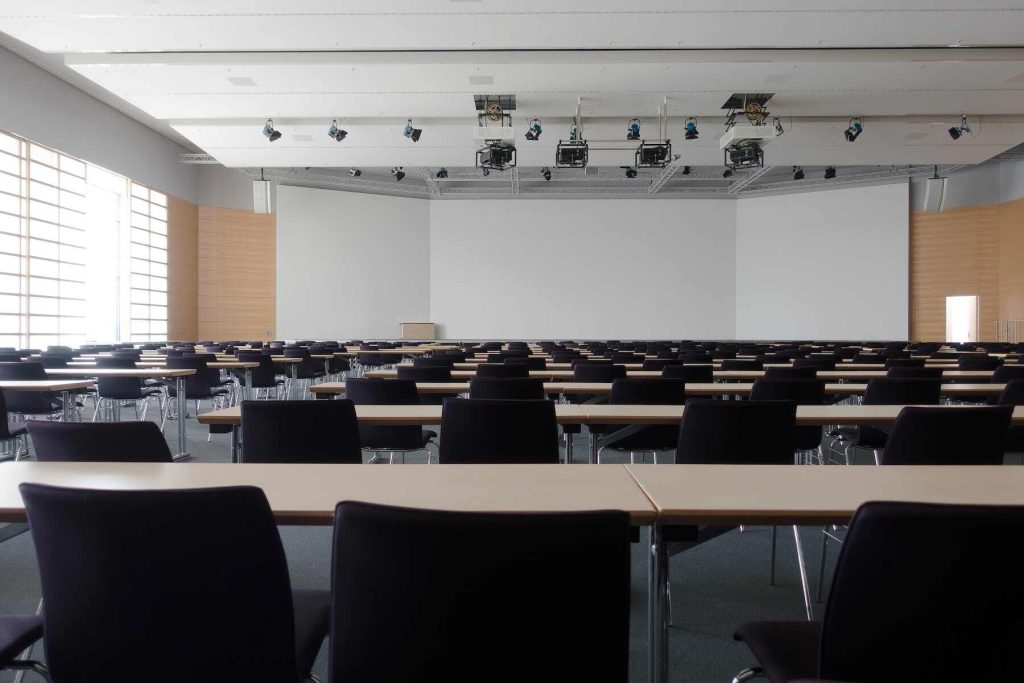 An auditorium with tables and chairs