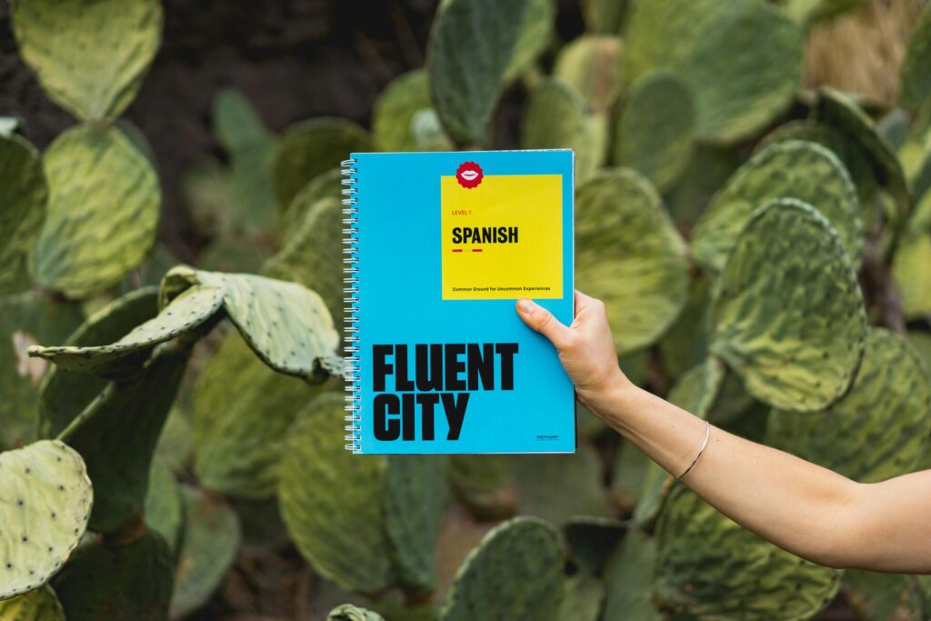 Hand holding a Spanish language teaching book