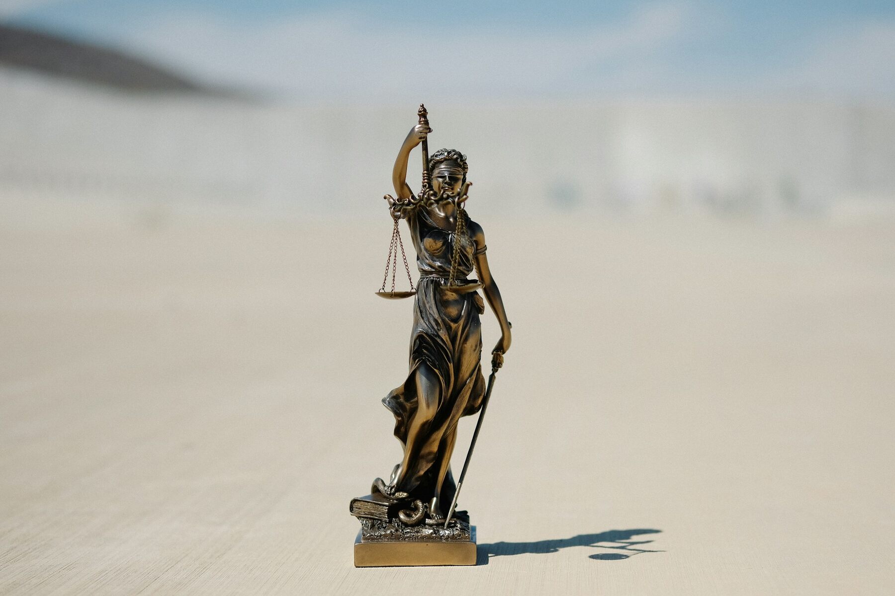 A statue of Lady Justice holding a sword and scale